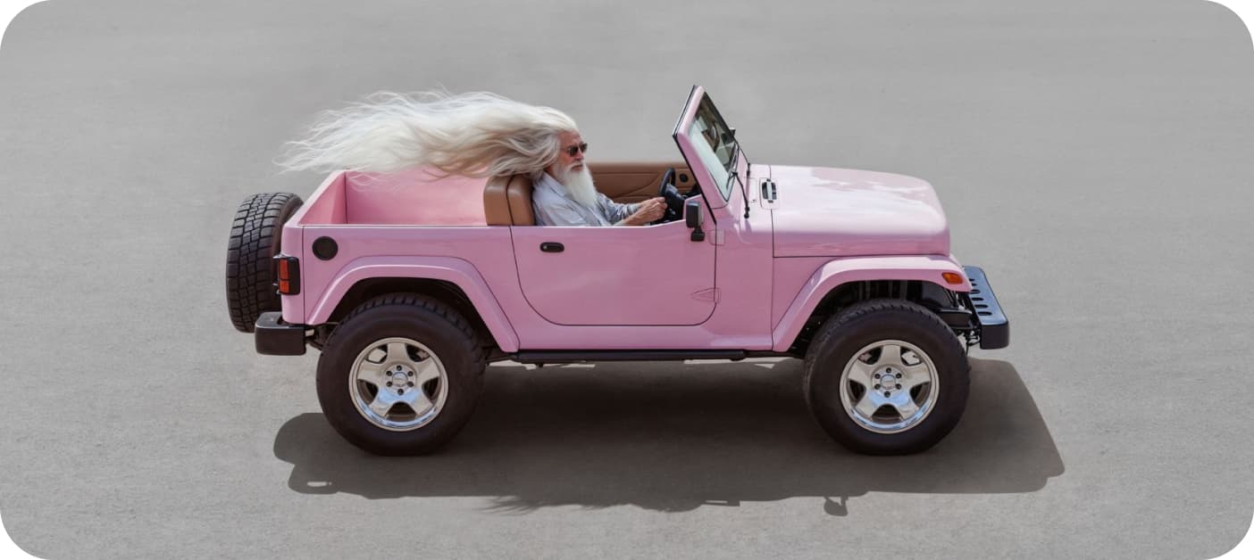 Rick Rubin look alike driving a pink jeep